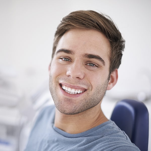 A man at the dentist smiling