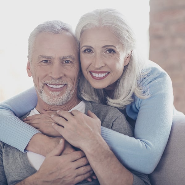 Mature couple smiling as they hugging