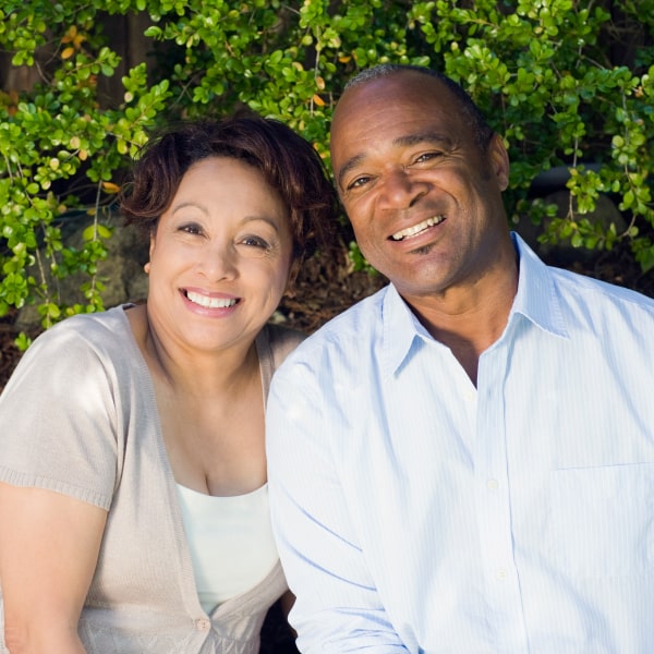 A mature couple smiling in a park